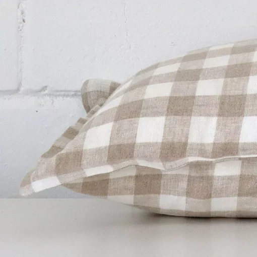 Horizontal edge of gingham large cushion cover is shown. The designer fabric can be seen from this side view.