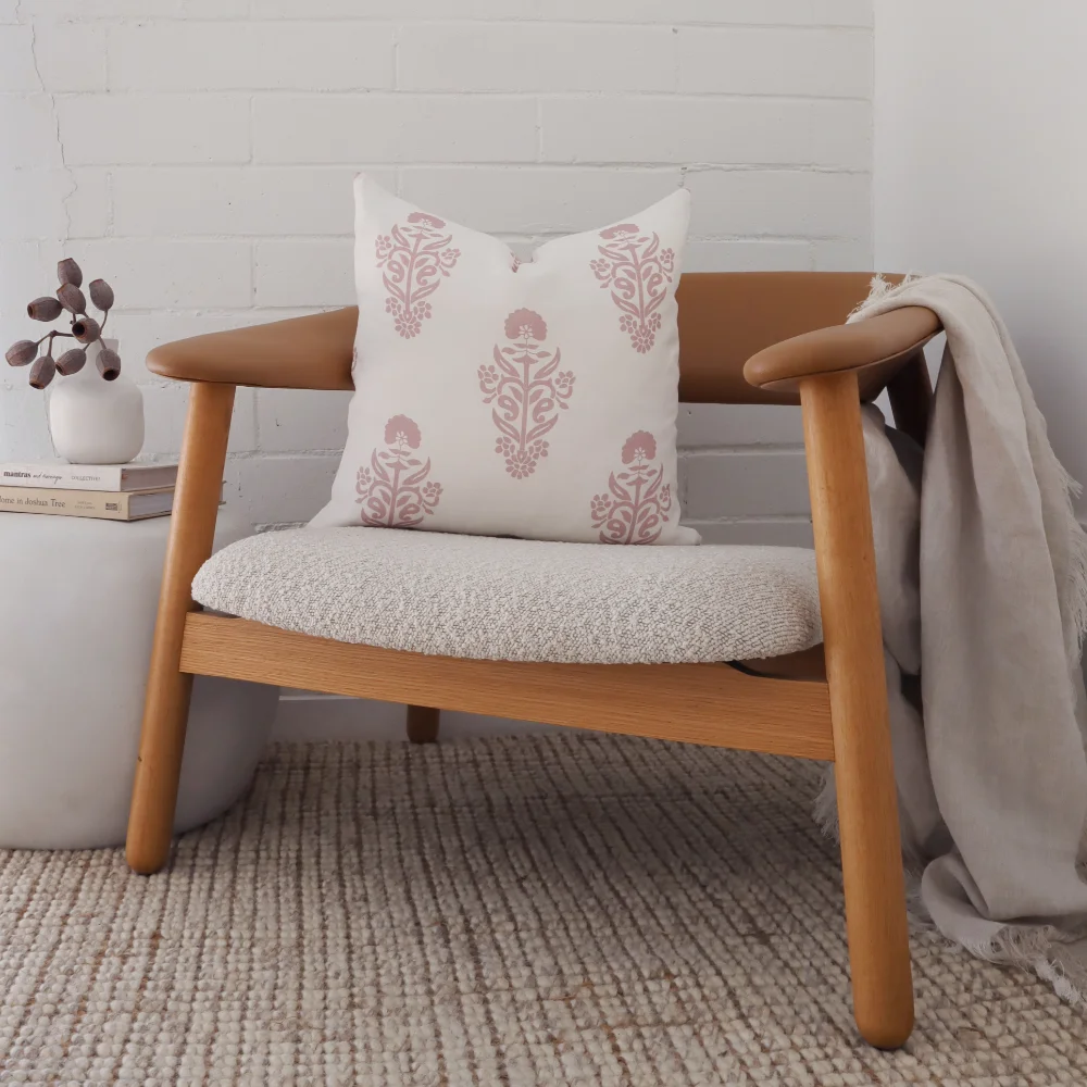 A fine timber chair has a patterned cushion placed on it.