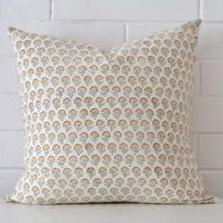 A large cushion cover that has a unique design is shown vertically against a brick wall.