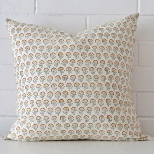 A large cushion cover that has a unique design is shown vertically against a brick wall.