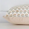 A large floral cushion cover is laid flat. This angle shows the side of the designer fabric.