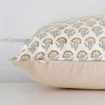 A large floral cushion cover is laid flat. This angle shows the side of the designer fabric.