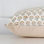 Rectangle floral cushion laying flat. The viewpoint highlights the seams of the designer fabric.