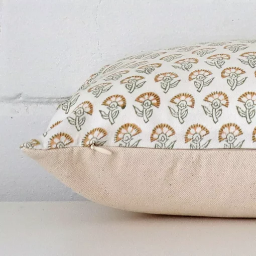Rectangle floral cushion laying flat. The viewpoint highlights the seams of the designer fabric.