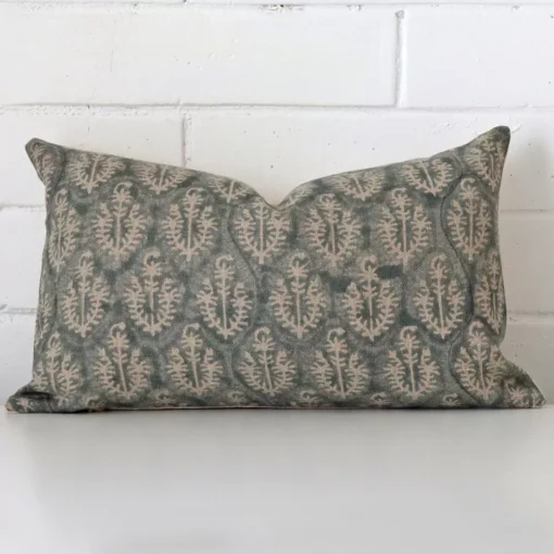 A lovely rectangle cushion cover arranged in front of a white wall. The style complements the designer material.