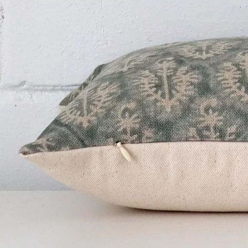 A side shot of a designer cushion cover. The angle shows the edge of the rectangle shape.