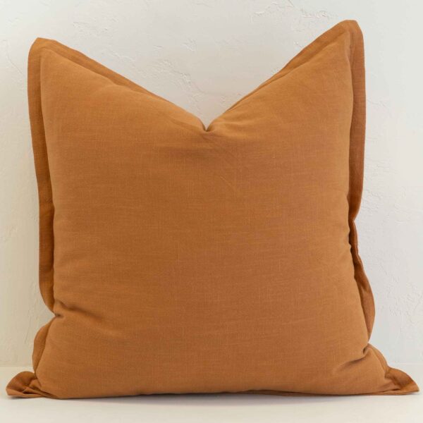 Ginger linen cushion with rich warm orange tone and woven texture.