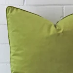 A zoomed view of this velvet green cushion’s corner that has a large size.