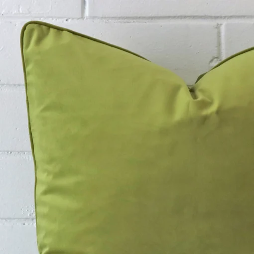 A zoomed view of this velvet green cushion’s corner that has a large size.