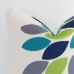 Close up view showing a corner of this patterned linen cushion in a square size and with colourful colouring.