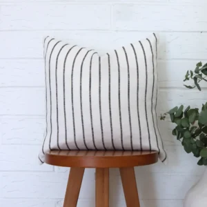 A high chair with a black and white cushion placed upon it.