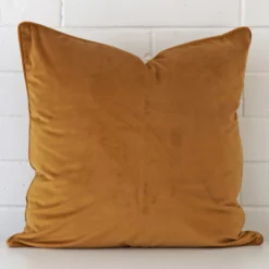 An alluring velvet large cushion cover in honey mustard.