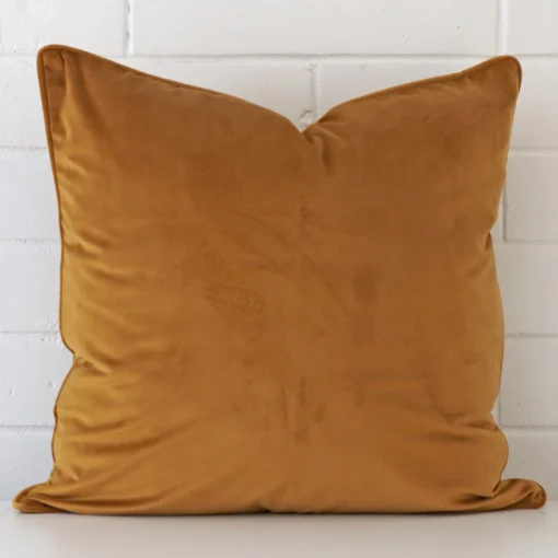 An alluring velvet large cushion cover in honey mustard.