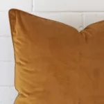 A close up shot showing the top left side of this large velvet cushion cover. The honey mustard tone is shown up close.