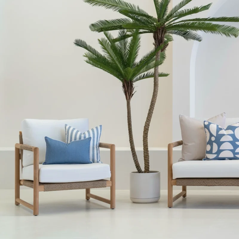 A white sofa with 4 horizon cove outdoor cushions sitting on it.