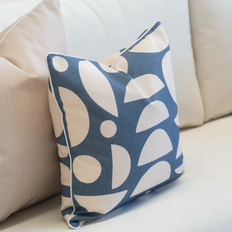 A white sofa styled with 2 horizon cove outdoor cushions.