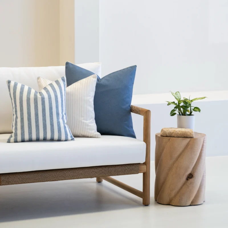 The horizon cove set of 3 outdoor cushions are displayed on a white sofa.