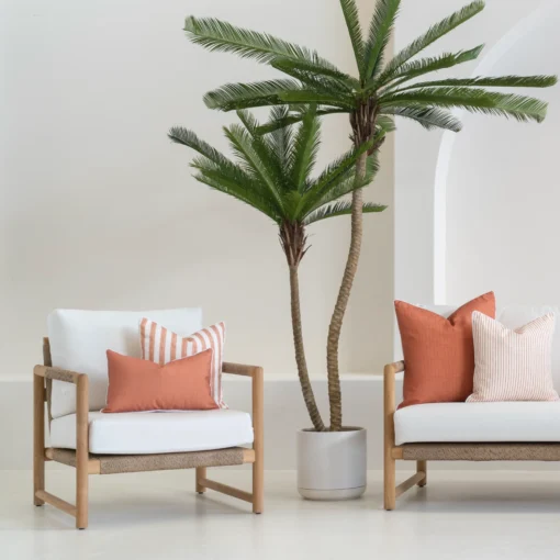 Outdoor seating displaying 4 horizon rust outdoor cushions on a white sofa.