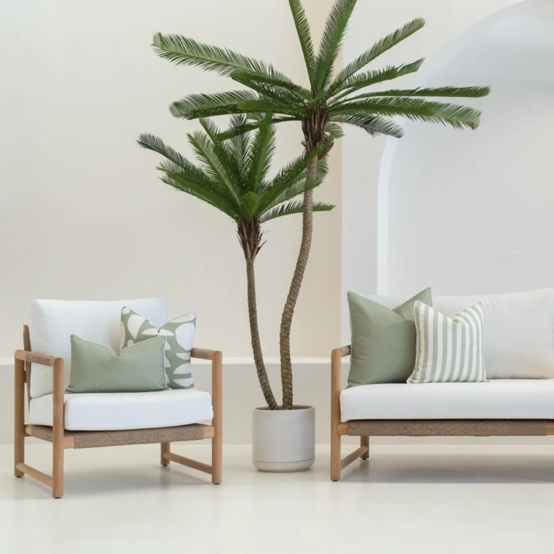 White sofa in an outdoor living room showing 4 horizon sage outdoor cushions.