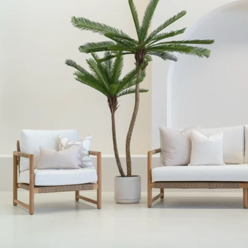 White sofa in an outdoor living room styled with 4 horizon sand outdoor cushions.