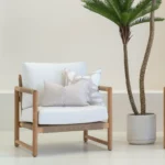 A wooden armchair showcasing 2 horizon sand outdoor cushions.