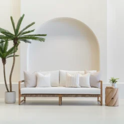 Horizon sand outdoor sofa cushions in a set of 5 are styled on a white sofa.