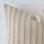 Zoomed photo of the top left corner of this striped cushion cover. The image clearly shows the designer material and large dimensions.