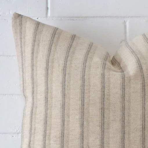 Zoomed photo of the top left corner of this striped cushion cover. The image clearly shows the designer material and large dimensions.