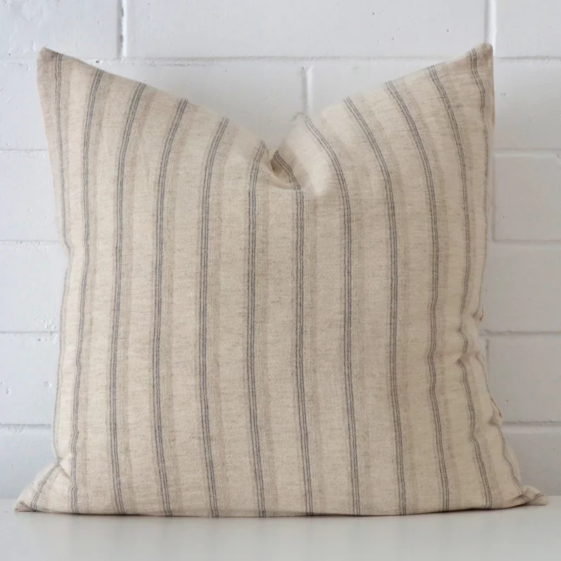 iris-striped-designer-cushion-cover-art103-55c A brick wall that has a striped cushion cover positioned in front of it. It has an exquisite designer material and a lovely large shape.