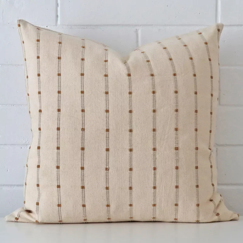 ivy-striped-designer-cushion-cover-art101-55c Striped cushion leans elegantly against a brick wall. It has been crafted from a high quality designer material and has a large size.