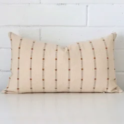 A hero shot of a striped rectangle cushion cover. It is made from a deluxe designer fabric.