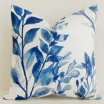 Cream cushion cover featuring blue painted leaf branches.