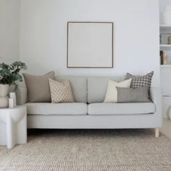The elegant Jude sofa cushions, a set of 5 designer cushions gives the stylish look of a grey sofa in a living room.