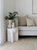 A corner of a grey sofa is styled with the two designer cushions from the Jude sofa cushions set of 5.