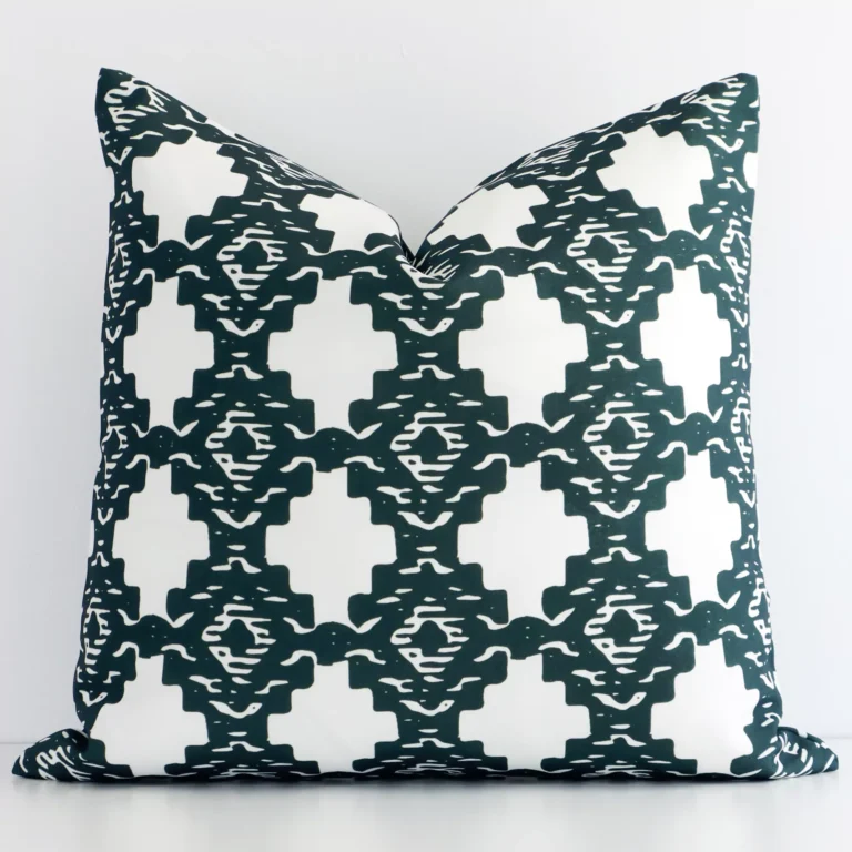 A premium dark green outdoor cushion boasting a geometric design and in a square shape.