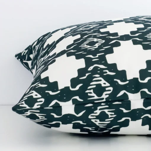 Side edge of geometric square cushion. The outdoor material and dark green colour can be seen from this lateral viewpoint.