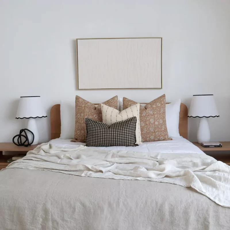 4 designer cushions from the Laurel bed set are elegantly arranged on the bed adding a touch of beauty to the space.