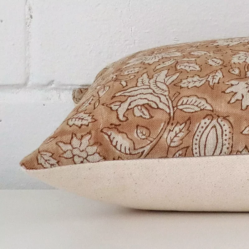 Large floral cushion laying flat. The viewpoint highlights the seams of the designer fabric.