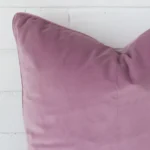 A close up image of this large cushion. The image shows details of its velvet fabric and lavender colour.