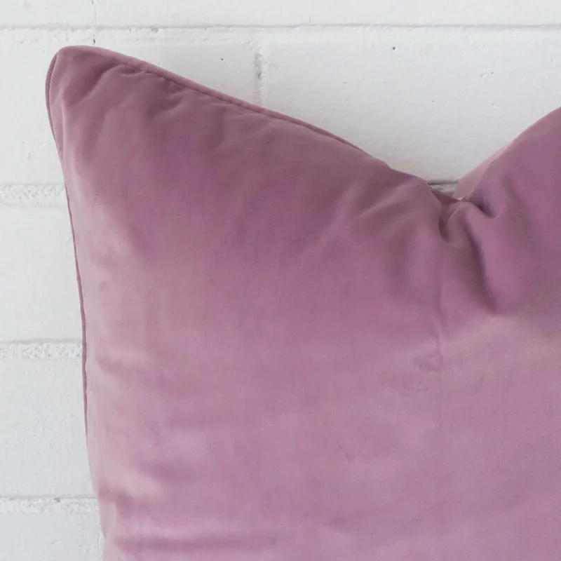 A close up image of this large cushion. The image shows details of its velvet fabric and lavender colour.