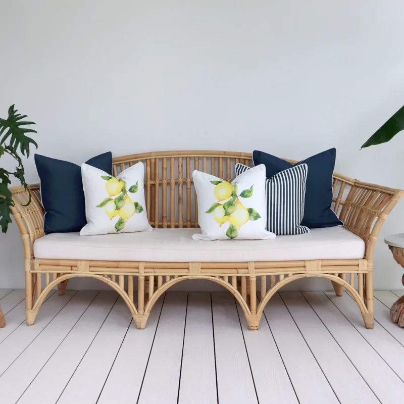 An inviting outdoor lounge area featuring a comfortable seat adorned with 5 beige cushions.