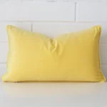 A hero shot of a rectangle cushion cover. It is made from a deluxe velvet fabric and features a lemon yellow colour.