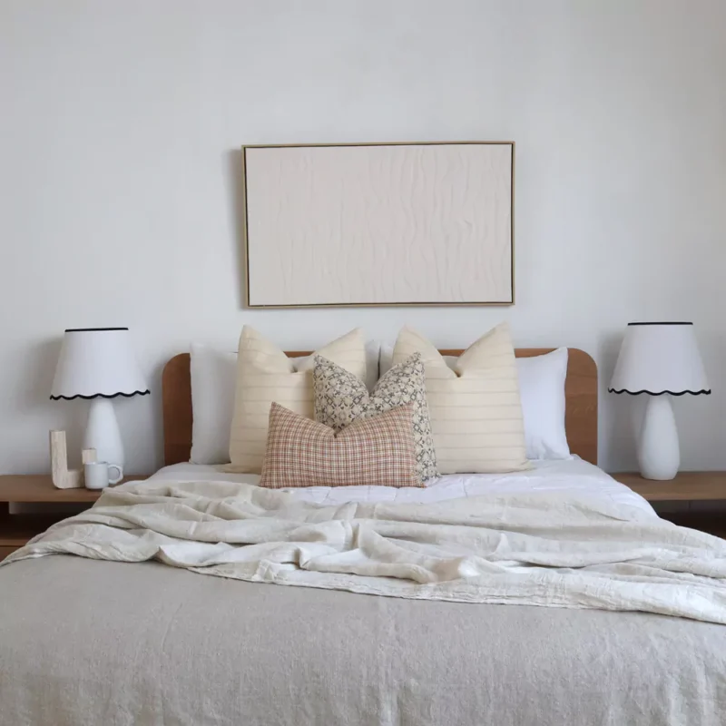 4 designer cushions from the Lennox bed set arranged beautifully on a bed.