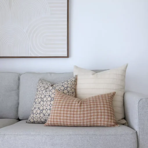 Cushions from the 3 designer couch cushions for the Lennox set are arranged in the corner of an elegant grey sofa.