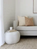 A corner of a grey sofa is styled with the two designer cushions from the set of 5 Lennox sofa cushions.