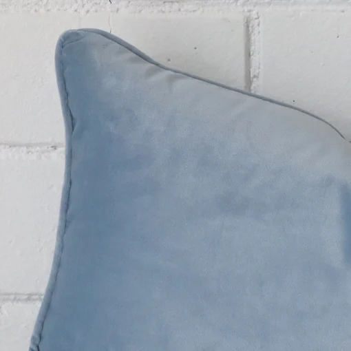 Close up of a velvet rectangle cushion in light blue colour.