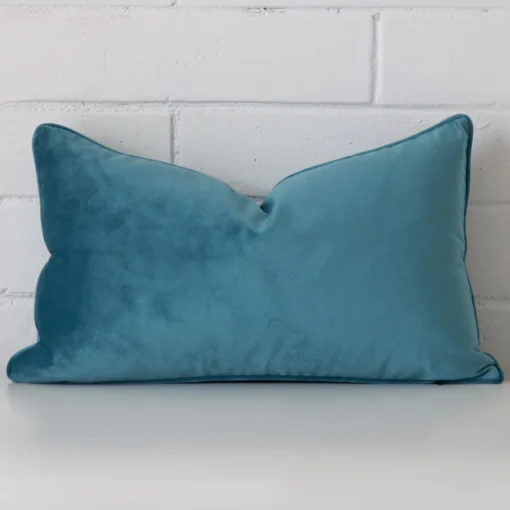 A superior velvet teal cushion cover in a classy rectangle size.