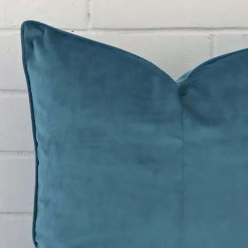 Macro image of a velvet large cushion cover. The shot shows the teal hue more thoroughly.