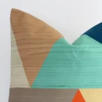Zoomed in visual of colourful linen square cushion cover. The intricacies of its geometric design are visible.