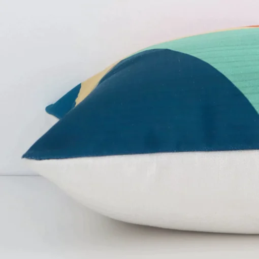 Square linen cushion cover positioned flat to show seams. The colourful hue and geometric design are shown between front and rear fabric panels.